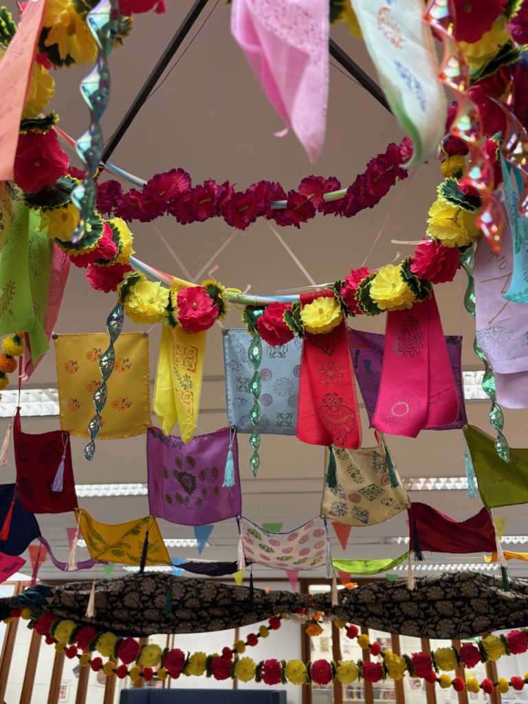 Colourful silk pocket squares/ scarfs/ kerchiefs with block printed patterns suspended in a canopy style installation