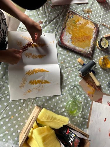 Making a fern print on recycled card at Happy Streets Festival
