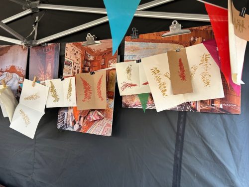 Finished botanical prints drying on a line at the festival stall