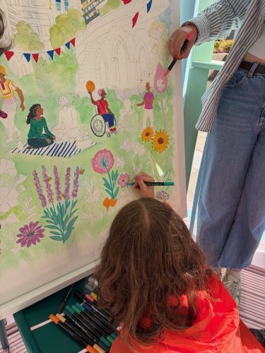 Participants adding colour and detail to the Culture Mile canvas