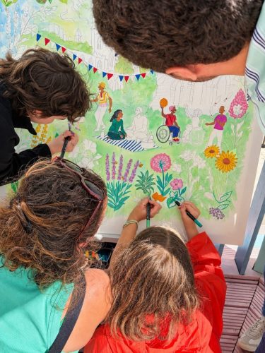 Participants colouring the Culture Mile giant canvas together