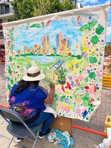 Artist Roopa Basu painting the East Village giant canvas