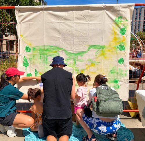 Early in the day at East Village: families beginning to colour the drawn canvas
